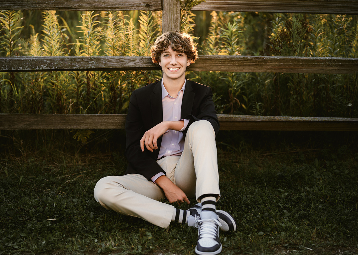Captivating senior portrait of a high school boy taken in the scenic landscape of Milwaukee, Wisconsin. This outdoor photograph captures the essence of youth and adventure, making it a memorable representing high school year. 