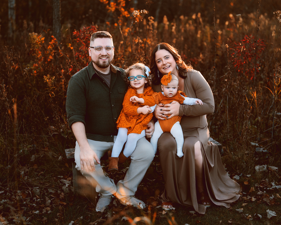 Beautiful autumn family picture in the natural setting. Stunning fall colors in the field of Riveredge Nature Center. Wisconsin family photography.