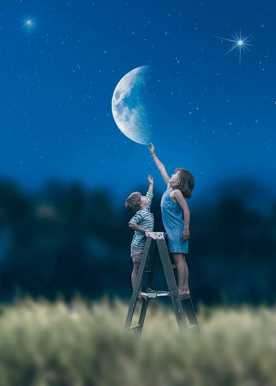 A very creative fine art style of picture of siblings. Pretending they are touching the moon in the sky. Great photograph taken at Mequon Wisconsin. 