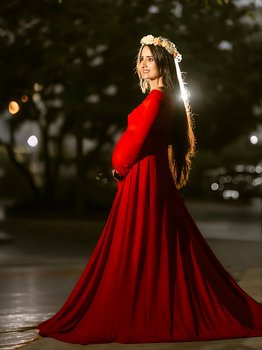Outstanding maternity picture with red long dress. 