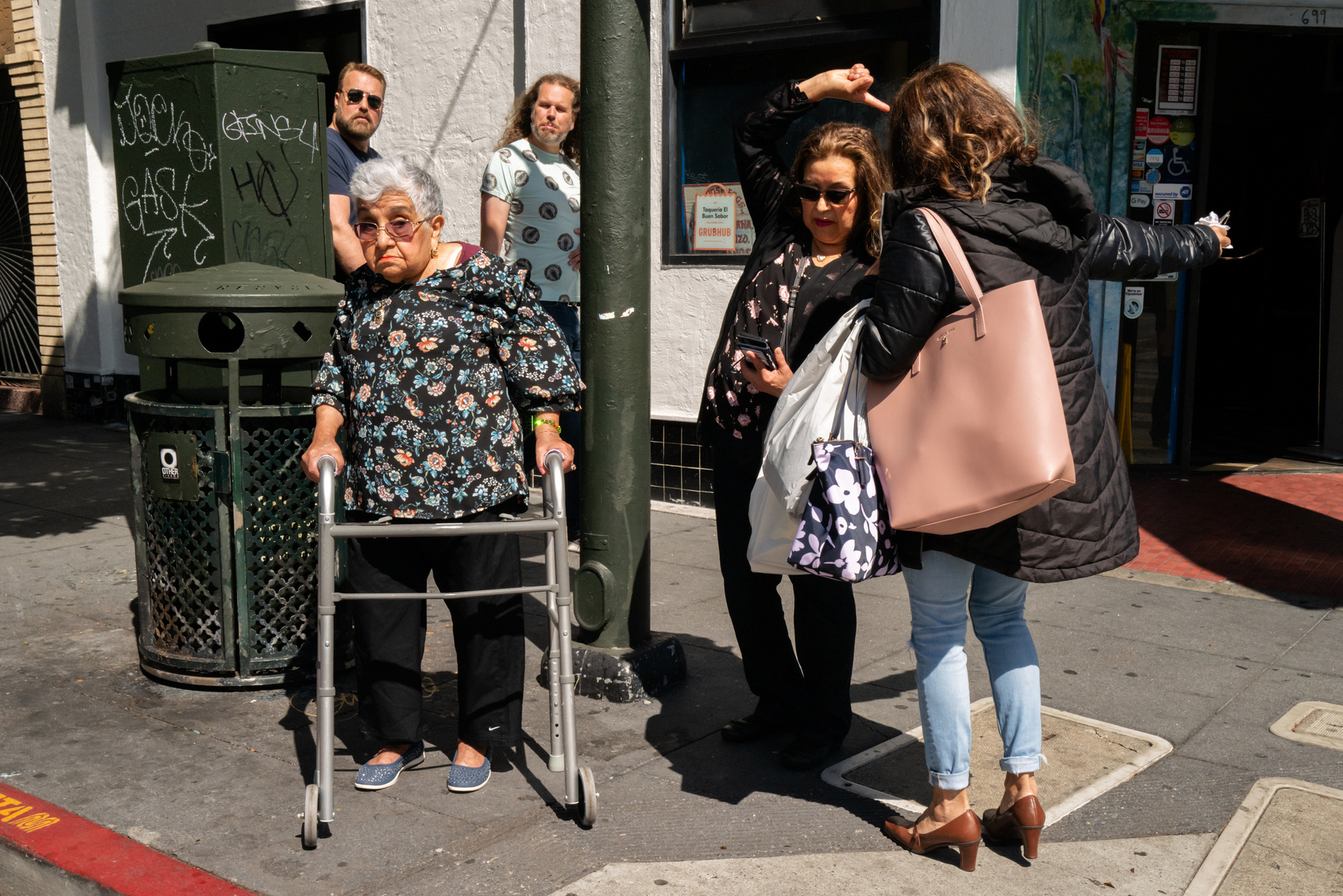 People waiting at the corner, figuring out which direction they should go.