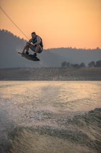 Person wakeboarding during the sunset.