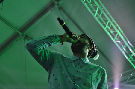 A singer stands over the camera while singing at the Snowglobe Music Festival.