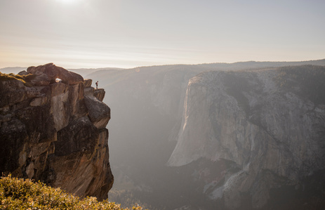 A person stands on the edge of Taft Point overlooking El Capitan in Yosemite.