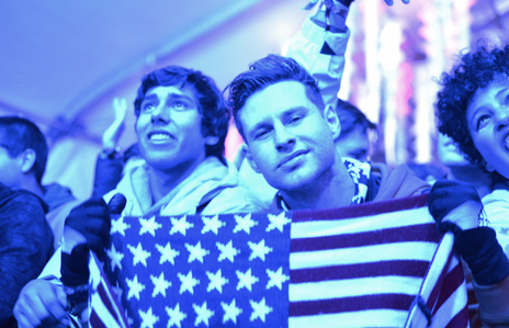 A man holds up an American Flag for the camera at the Snowglobe Music Festival.