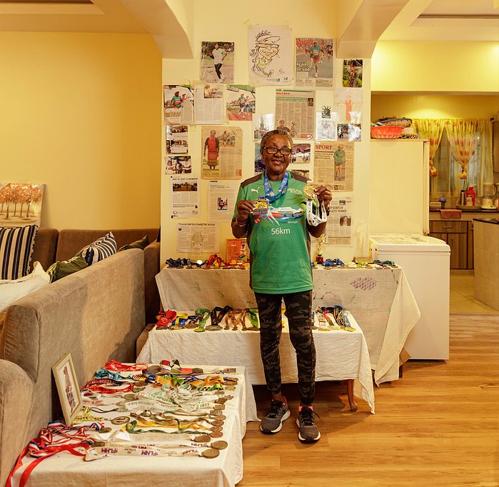 Joyce Nduku. Tata Marathoner at her home in Athi River Nairobi with
her medal