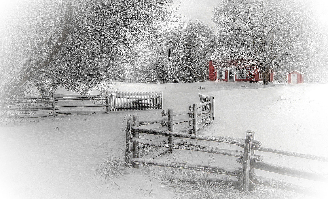 Red farmhouse during a blizzard in Cheltenham, Ontario