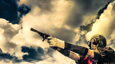 Constance Bashford holding gun aiming somewhere in the sky, clouds.