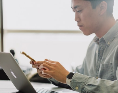 Man checking his phone while working.