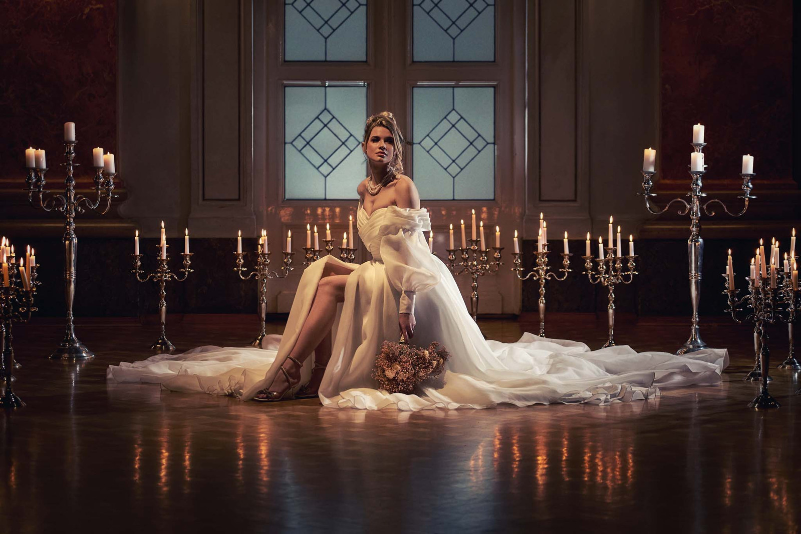 Beautiful bride posing in romantic atmosphere with candles