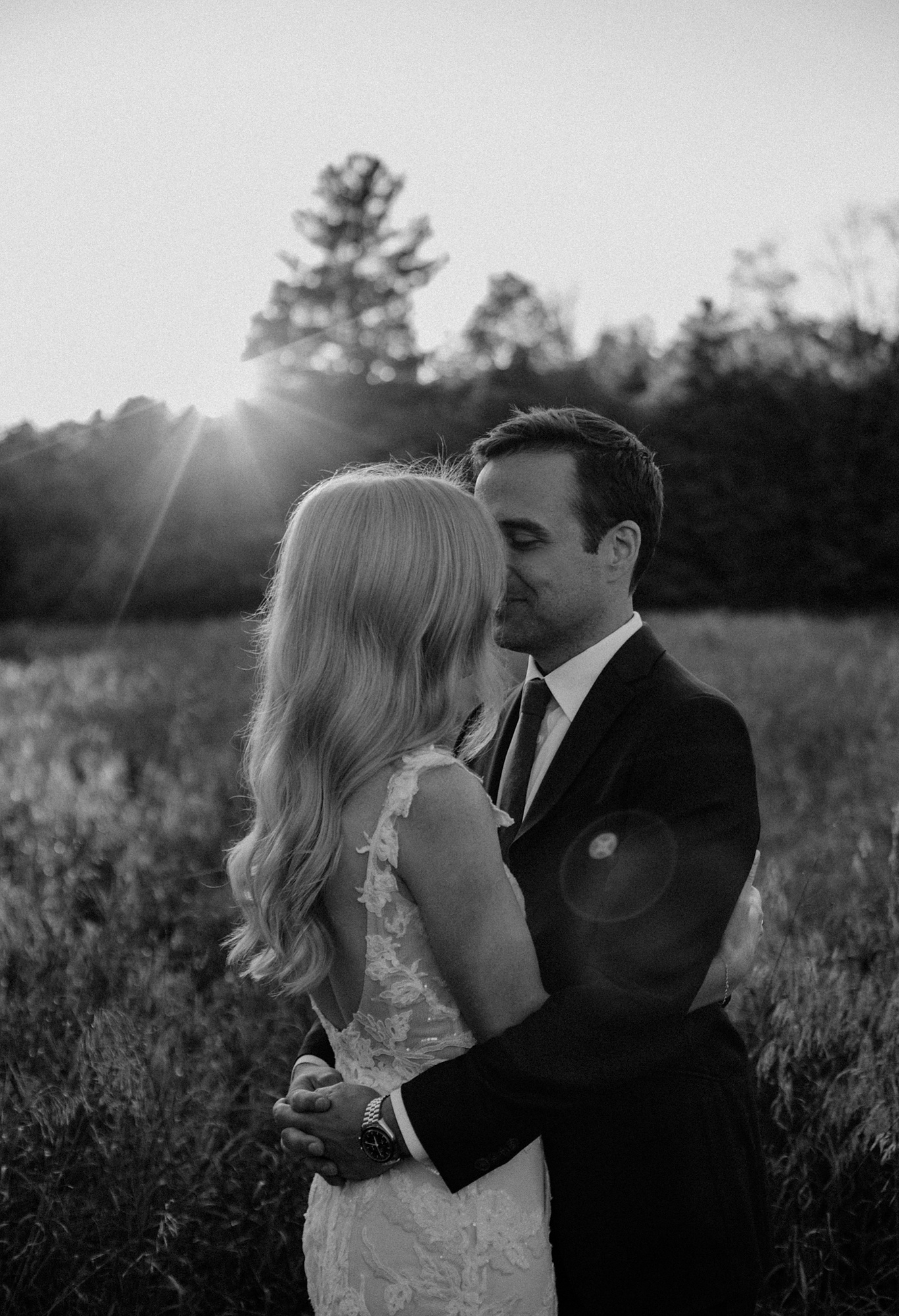Beautiful Wedding Couple hugs each other at Hayfield. Location is in the Catskills, New York.