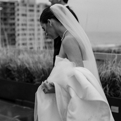 Wedding Couple on rooftop in NYC Walking during sunset. Shot by Hudson Valley Wedding Photographer.