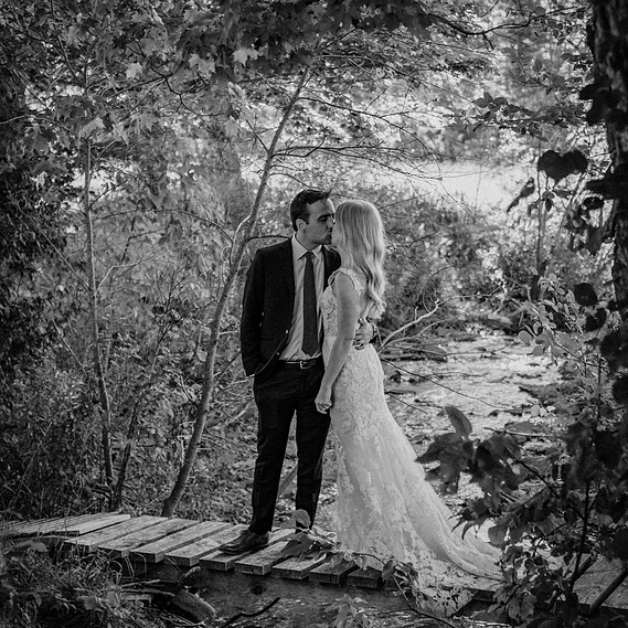Classy couple kissing on a bridge. Timeless Photograph taken at Hayfield, Location The Catskills in Upstate New York. Villetto Photography.