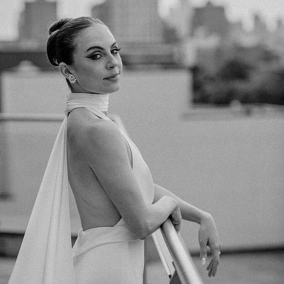 Stylish bride looking into the light on a rooftop in Brooklyn, New York. Photographed by Villetto Photography