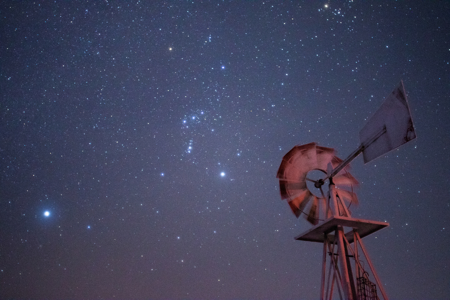 The Orion constellation rises over a windmill a few miles west of Kalispell on Jan. 19, 2020.