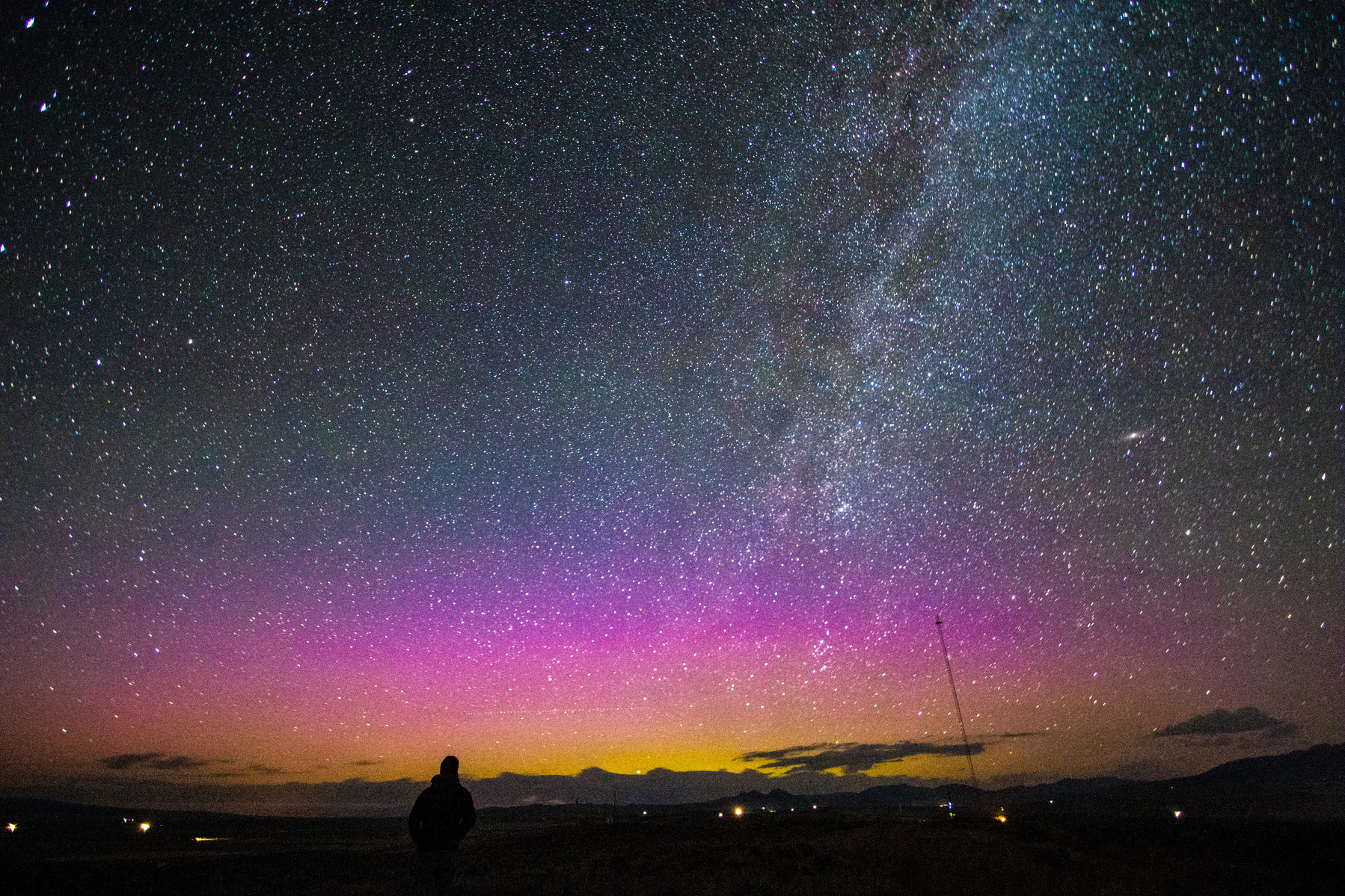Jordan Ingram, sports editor for the Livingston Enterprise, gazes on the Aurora Borealis, or Northern Lights, and the Milky Way from a hilltop overlooking Wilsall in the wee hours of Monday morning.