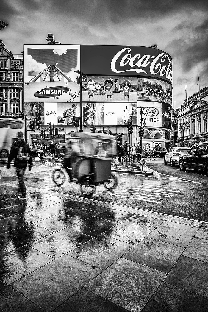 Piccadilly in the rain at dusk by Mark Burley (a black and white photo)