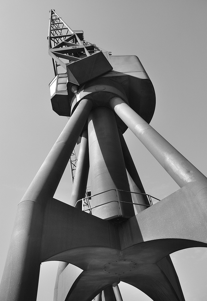 A black and white photo of a Dockland Crane by Mark Burley