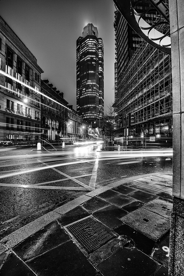 A black and white photo of The Nat-West Tower and light trails at night by Mark Burley