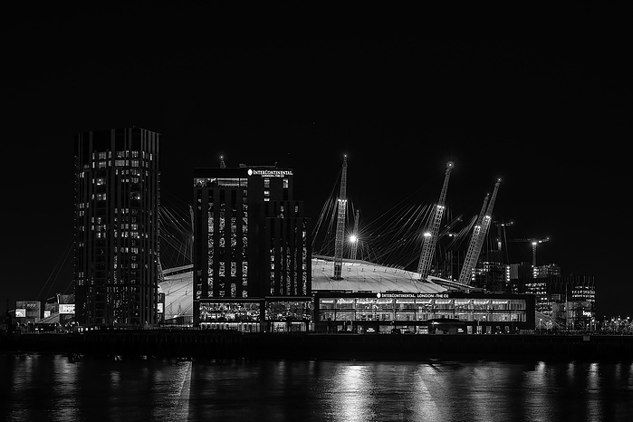 A black and white photo of The O2 at night by Mark Burley