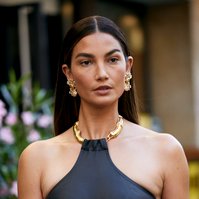 Lily Aldrige with gold accessories and halter neck dress