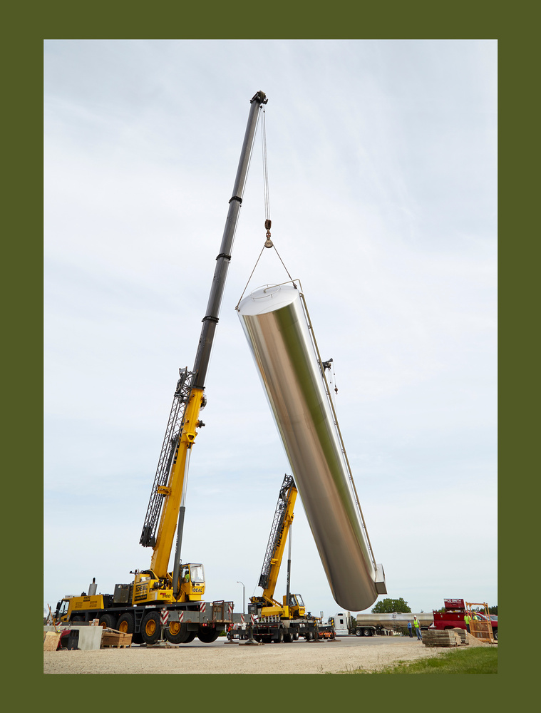 Construction photographer in Madison, Wisconsin highlighting heavy equipment operators erecting dairy silo.
