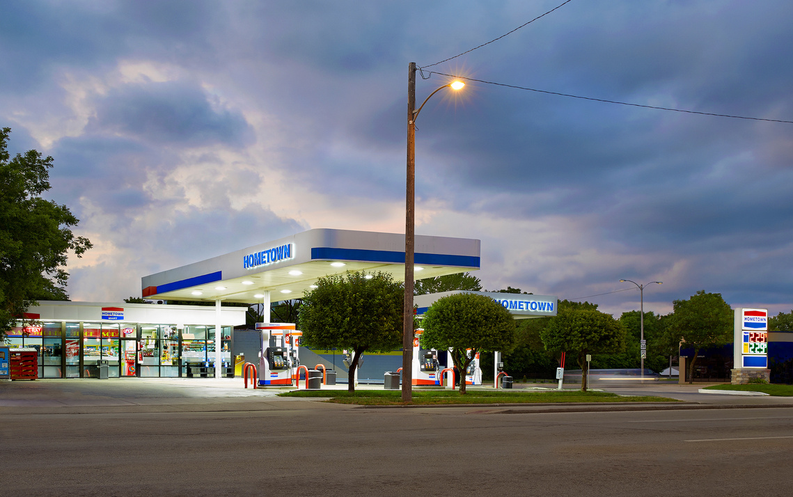 Architectural photography of gas station at dusk with storm clouds in the backdrop.Photographer - Madison, Wisconsin.