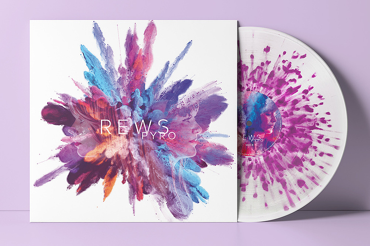 The Pyro album by Rews as a white vinyl record with dark pink spatter effect radiating from the centre. 