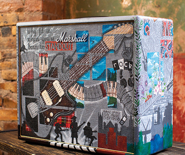 A Marshall guitar amplifier that has been painted by hand to reflect punk and Scottish heritage. It is most grey, with elements of gold, red and black tartan.