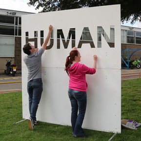 An 8 foot by 8 foot piece of MDF, with the word 