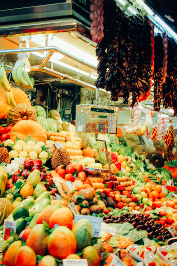 Close up color photo of the huge piles of fresh fruits and veggies at the Las Ramblas indoor market in Las Ramblas marketplace Barcelona Spain