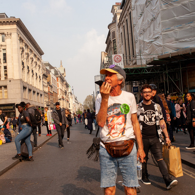'Man in an Aladdin Sain Tee Shirt looking like he is lost, London Street Photography Colour'