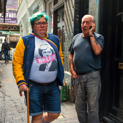 'Woman walking along the street with a sex pistols tee shirt on, Colour, London Street Photography'