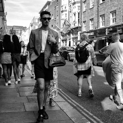 A man walking down old Compton streets, Soho, London black-and-white photography