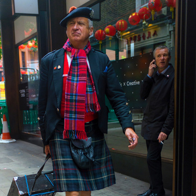 'A Scotsman wearing his kilt walks through Soho, London Street Photography Colour'