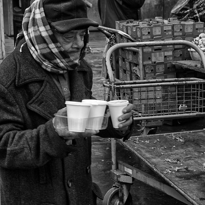'Old man holding three cups of tea, Black & White London Street Photography'