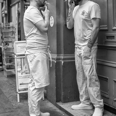 Two guys having a smoke, Soho, London black-and-white photography