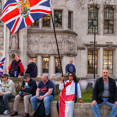 'Pro Brexit supporter sitting outside Westminster with an Union Jack Flag, London Colour Street Photography'