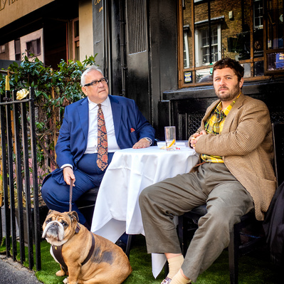two men and a dog, outside a restroom, Soho, Color street photography, London 