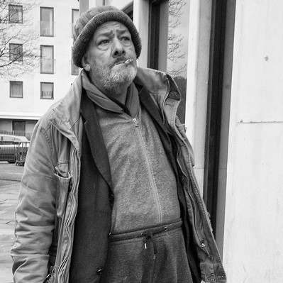 Rough sleeper smoking London black-and-white photography