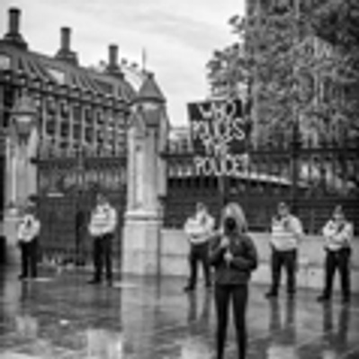 'Woman holding a placard outside the Houses of Parliament, Black Lives Matter Protests, London Black and White Street Photography'