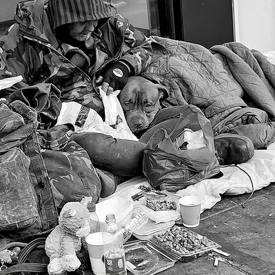 A man and his dog snuggled up to keep warm, London black-and-white photography