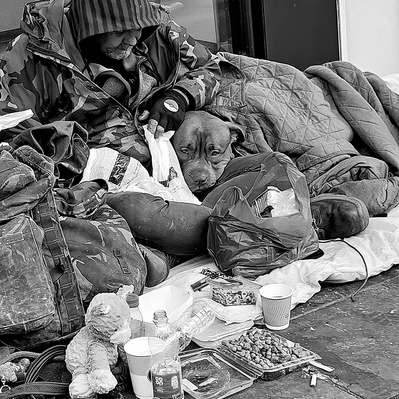 A man and his dog snuggled up to keep warm, London black-and-white photography