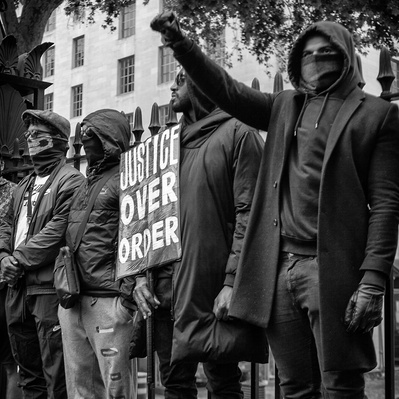 'Protester giving a black power salute at the Black Lives Matter protests, London Black and White Street Photography'