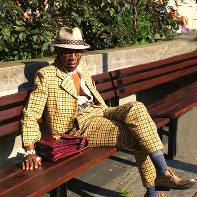 'Man in a smart suit and matching shoes sits on a park bench in Marble Arch, London Street Photography Colour' 