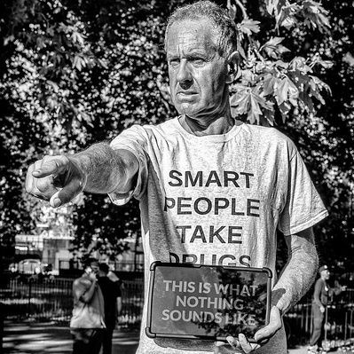 Man at speakers corner with a productive T-shirt, London black-and-white photography
