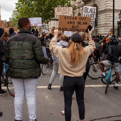 'Protester Holding up a placard outside Downing Street, London Colour Street Photography'