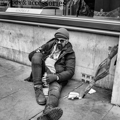 Man sitting on the floor having drunk alcohol London black-and-white photograph photography
