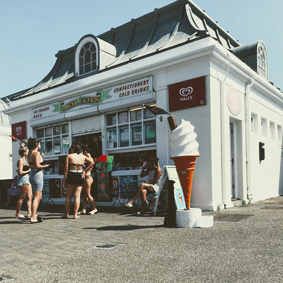 A group of girls queueing up for ice cream, Brighton seafront, Sussex, England, colour photography