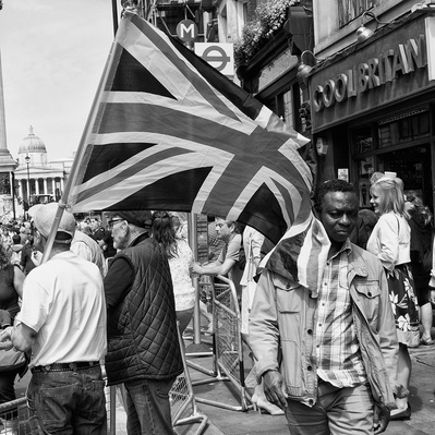 'Tommy Robinson Supporter with his arms in the air, London Black and White Street Photography'